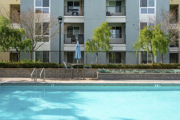 Resort-style pool with loungers at Mosaic Apartments, luxury living in prime urban location