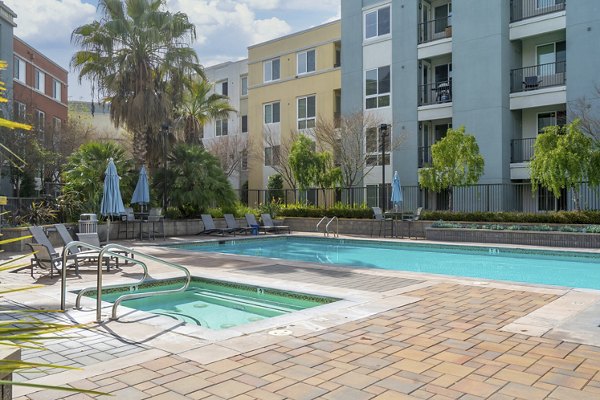 Modern outdoor pool with poolside seating at Mosaic Apartments, a Greystar luxury community