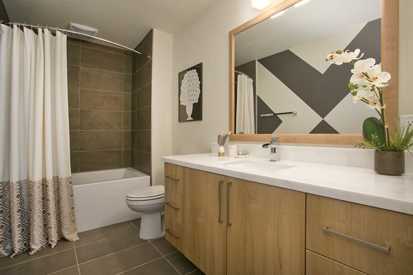 Luxurious bathroom with modern fixtures and elegant tiles in Sway Apartments