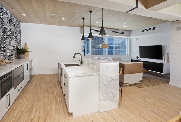 Modern kitchen area with stainless steel appliances at clubhouse in Sway Apartments, ideal for hosting gatherings and culinary experiences