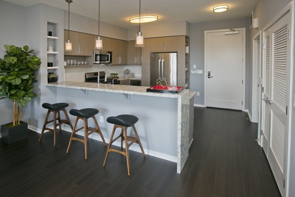 Modern kitchen featuring sleek cabinetry and stainless steel appliances in Sway Apartments, a Greystar luxury apartment community