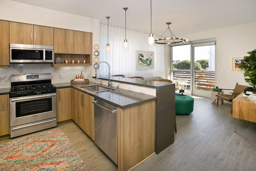 Modern kitchen with stainless steel appliances at Sway Apartments luxury living community