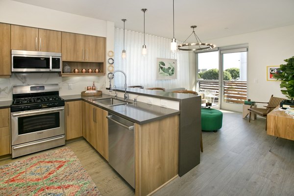 Modern kitchen with stainless steel appliances at Sway Apartments luxury living community