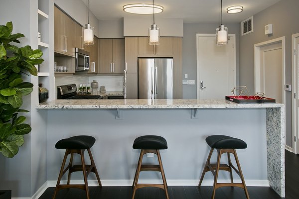 Modern kitchen with stainless steel appliances in Sway Apartments