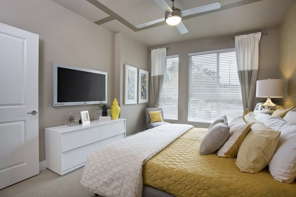Cozy bedroom with modern decor at Broadstone on 9th Apartments featuring luxury amenities