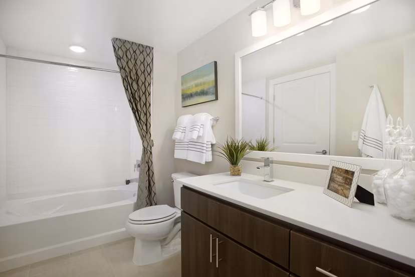 Bathroom featuring modern fixtures and large mirror at Broadstone on 9th Apartments