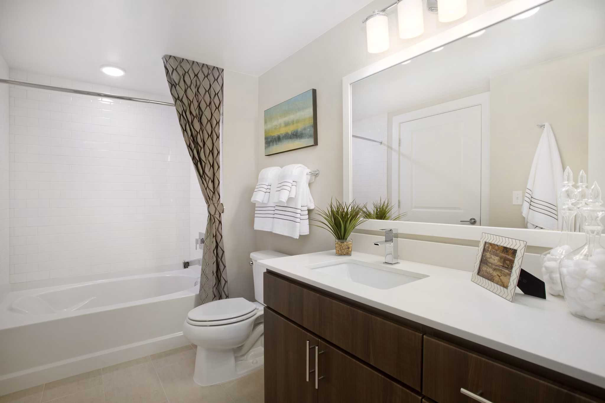 Bathroom featuring modern fixtures and large mirror at Broadstone on 9th Apartments