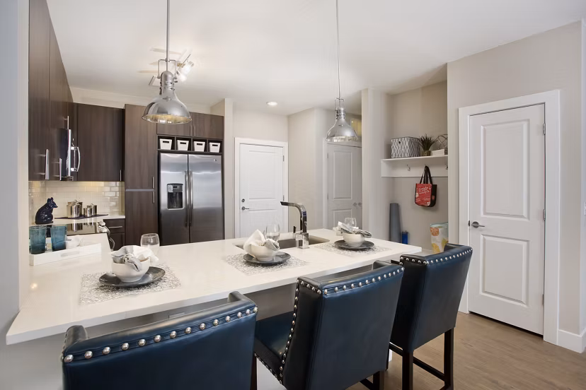 Broadstone on 9th Apartments: Modern kitchen with stainless steel appliances and granite countertops