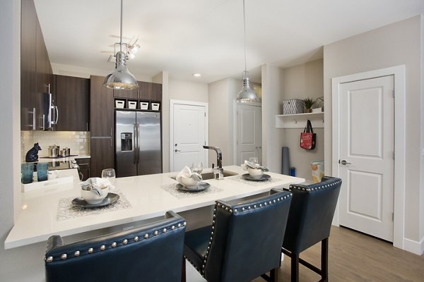 Broadstone on 9th Apartments: Modern kitchen with stainless steel appliances and granite countertops