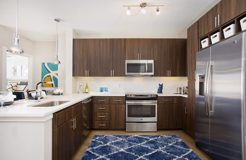 Broadstone on 9th: Contemporary kitchen with stainless steel appliances and quartz countertops in luxury apartments