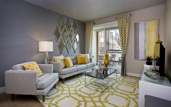 Spacious living room with modern dÃ©cor at Broadstone on 9th Apartments