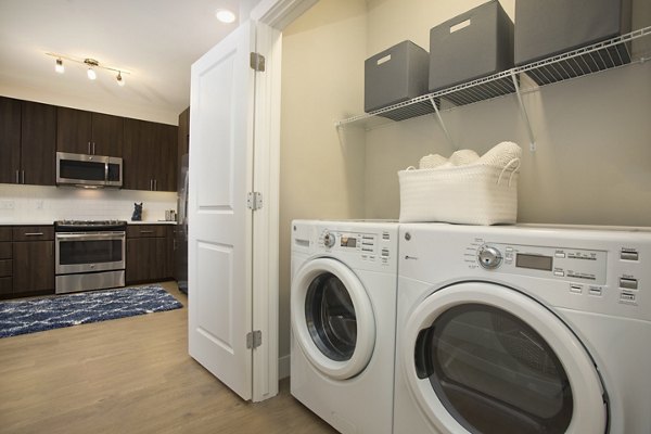 Laundry room with modern washers and dryers at Broadstone on 9th Apartments, luxury living in a prime location
