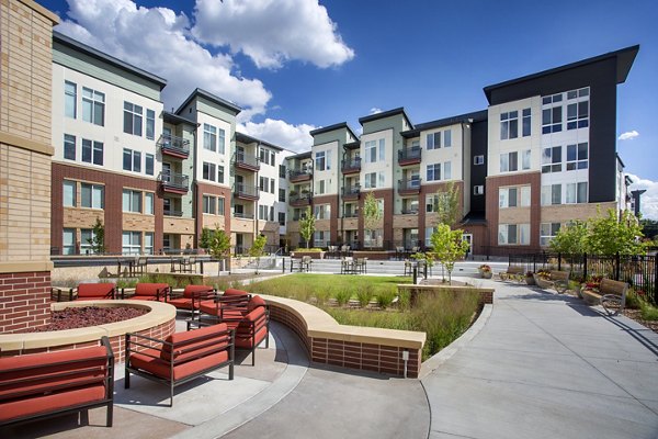 Broadstone on 9th Apartments: Tranquil courtyard featuring lush gardens and seating areas in Salt Lake City