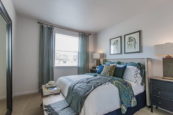 Spacious bedroom with modern decor at The Artisan Apartments, offering luxury living experiences
