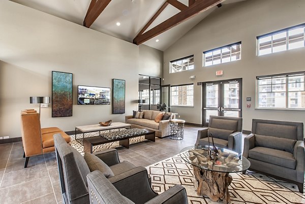 Clubhouse at The Artisan Apartments featuring modern decor and ample natural light, offering a luxurious space for residents to relax and socialize
