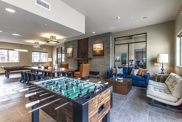 Games area with pool table and seating at The Artisan Apartments Perfect for social gatherings and relaxation in a modern luxury setting