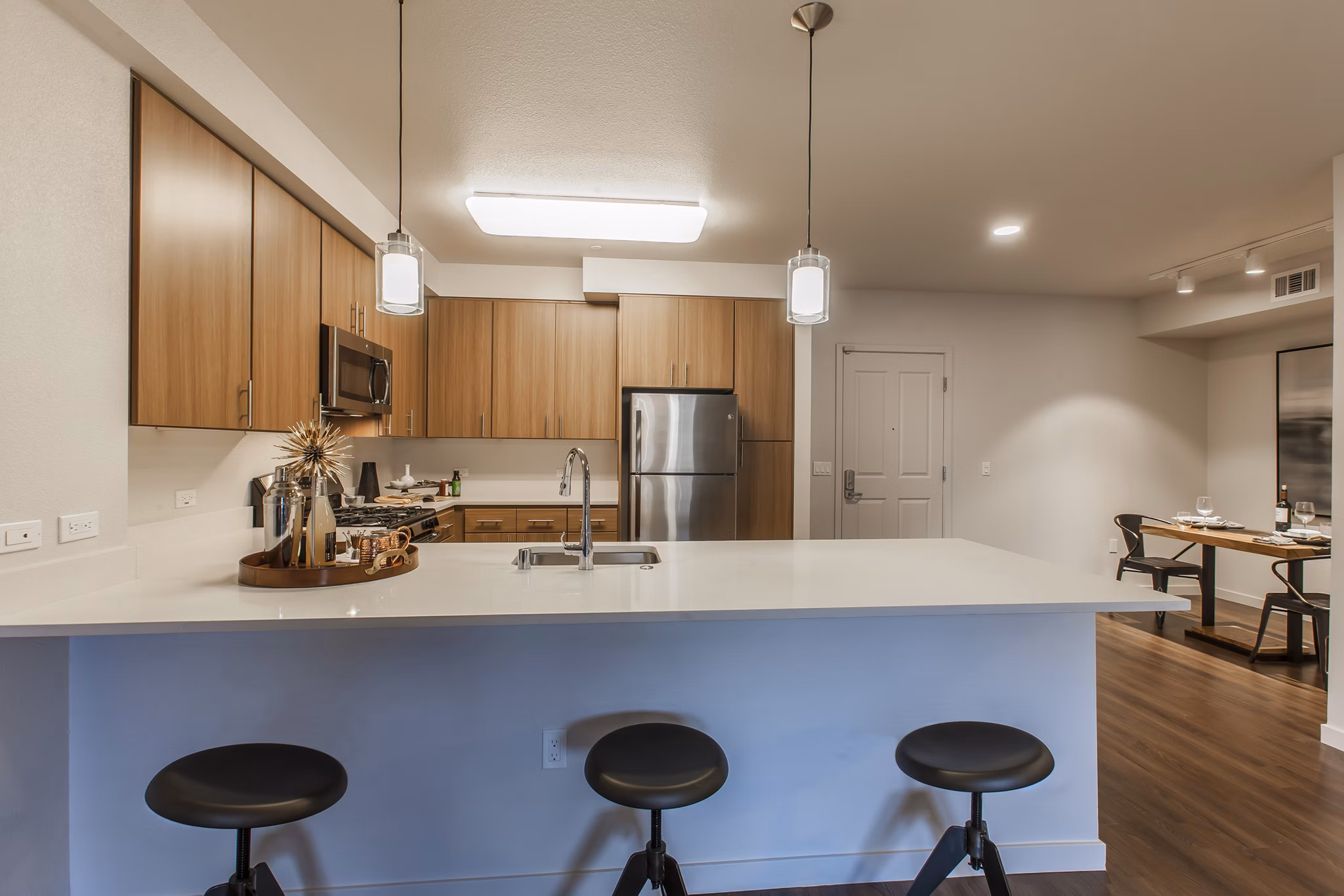 Modern kitchen with sleek countertops and stainless steel appliances at The Artisan Apartments