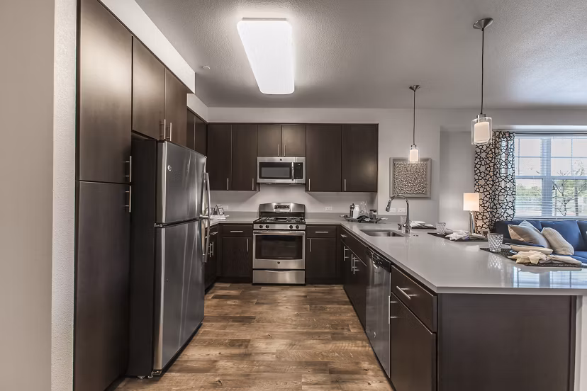 Modern kitchen with stainless steel appliances in The Artisan Apartments