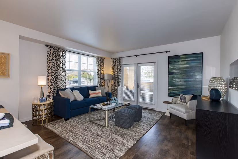 Spacious living room with contemporary decor at The Artisan Apartments, highlighting comfortable seating and stylish design