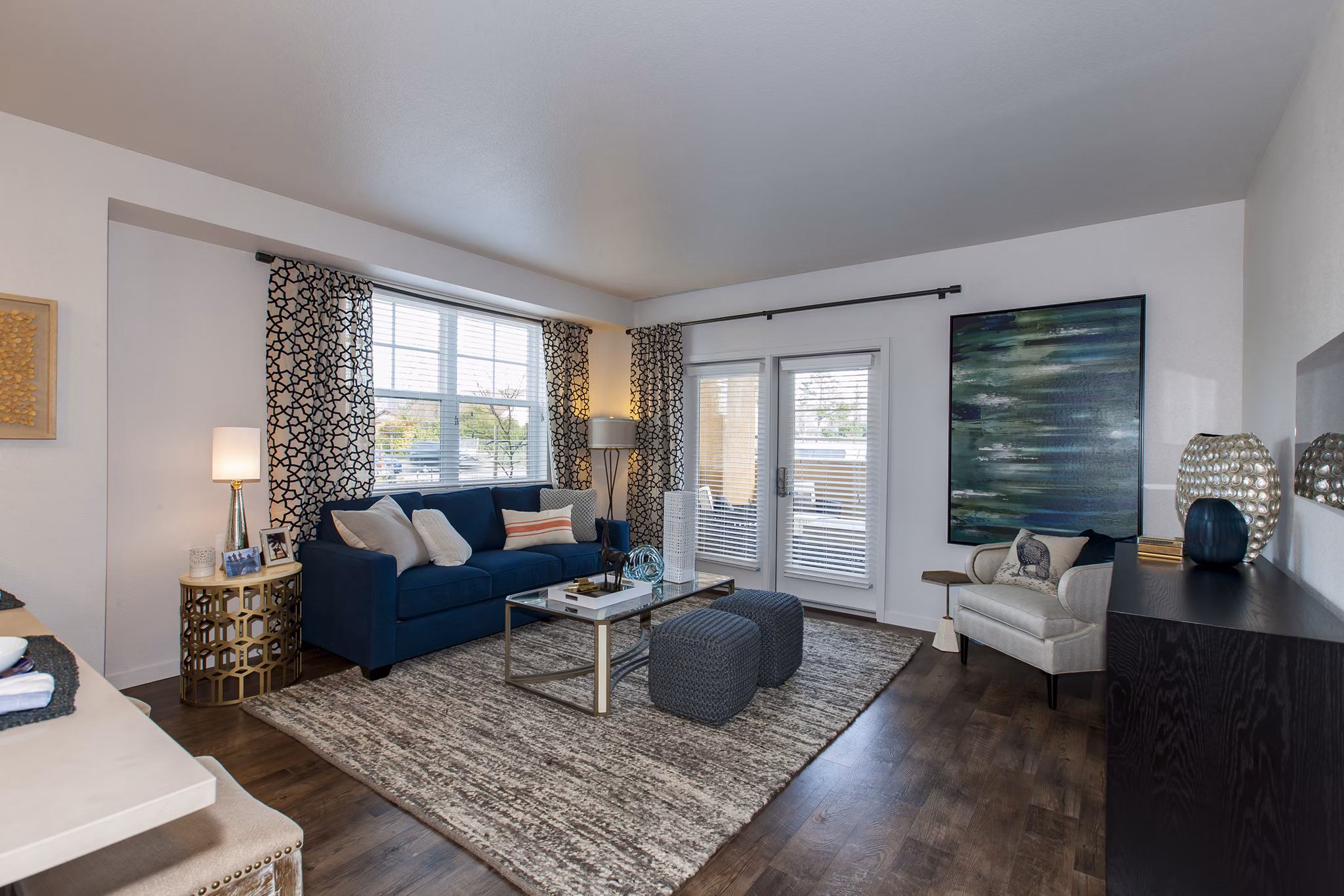 Spacious living room with contemporary decor at The Artisan Apartments, highlighting comfortable seating and stylish design