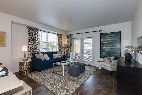 Spacious living room with contemporary decor at The Artisan Apartments, highlighting comfortable seating and stylish design