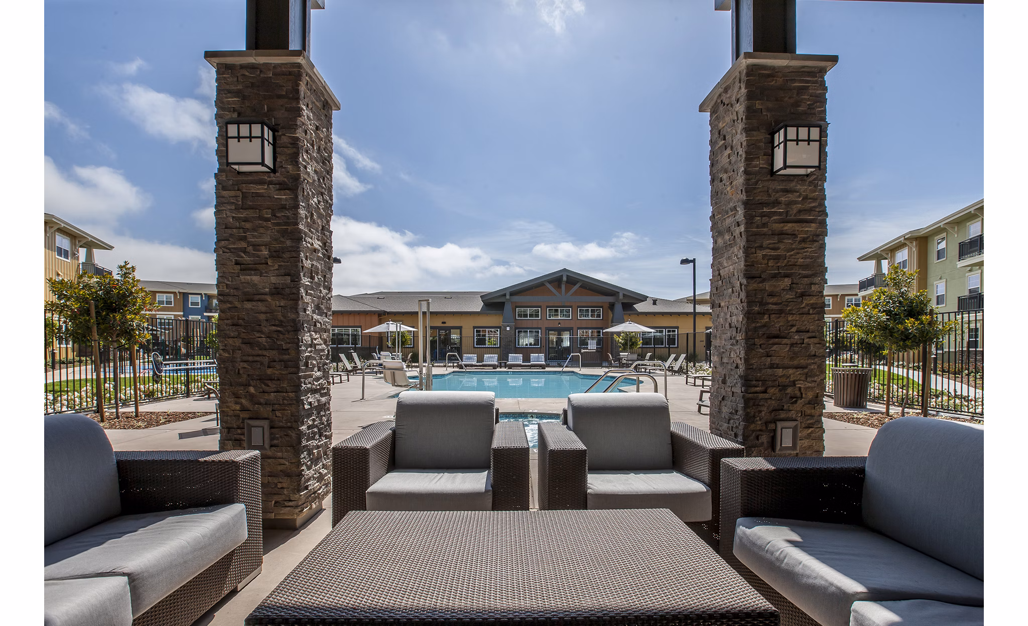 The Artisan Apartments: Modern patio space with outdoor seating and greenery