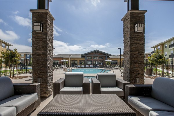 The Artisan Apartments: Modern patio space with outdoor seating and greenery