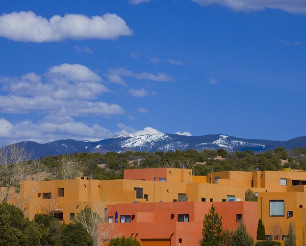Adobe-style luxury apartments with a picturesque mountainous landscape in the background