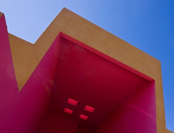 Colorful architectural structure with pink and orange walls in a vibrant urban setting