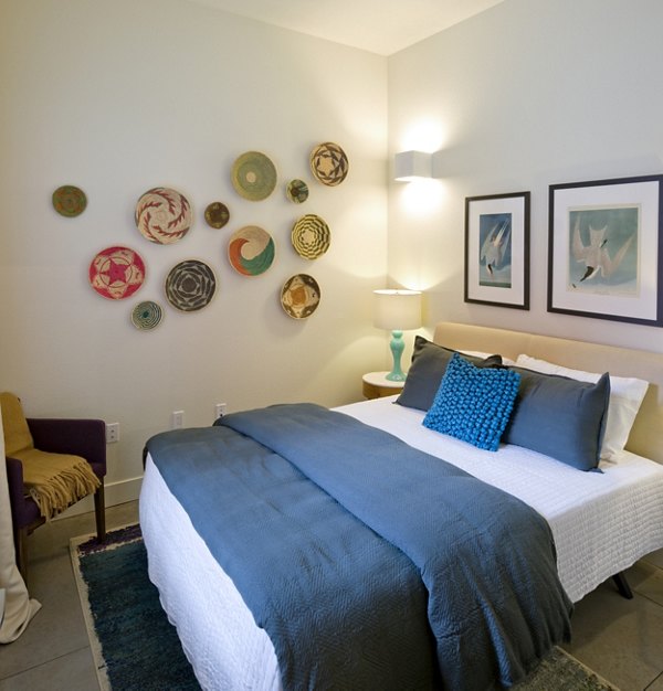 Cozy bedroom featuring a bed with decorative pillows and wall art in luxury apartments