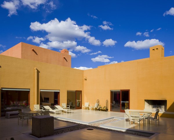 Modern outdoor patio area with cozy seating and a fireplace at luxury apartments