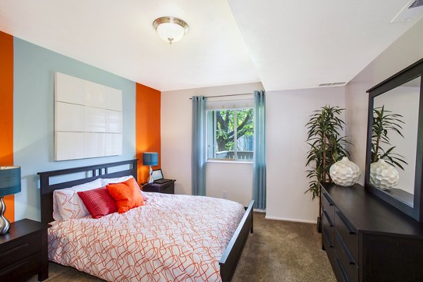 Bedroom with modern decor and plush bedding at The Pointe at Northridge apartments
