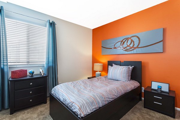 Spacious bedroom with modern furnishings at The Pointe at Northridge luxury apartments