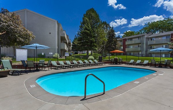 Poolside relaxation at The Pointe at Northridge apartments featuring luxurious outdoor swimming pool and lounge area
