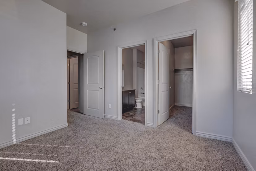 Cozy bedroom with stylish decor at Villas on Main Apartments, offering luxury living and comfort