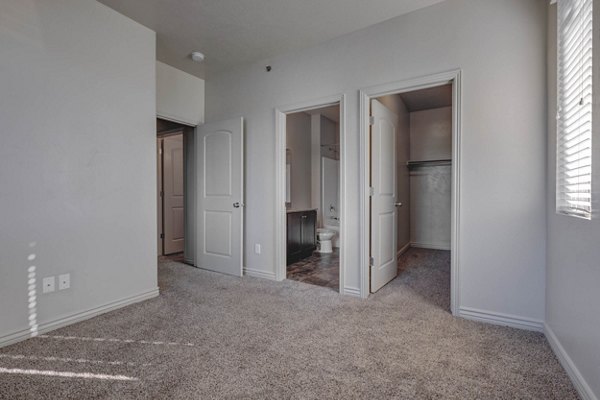 Cozy bedroom with stylish decor at Villas on Main Apartments, offering luxury living and comfort