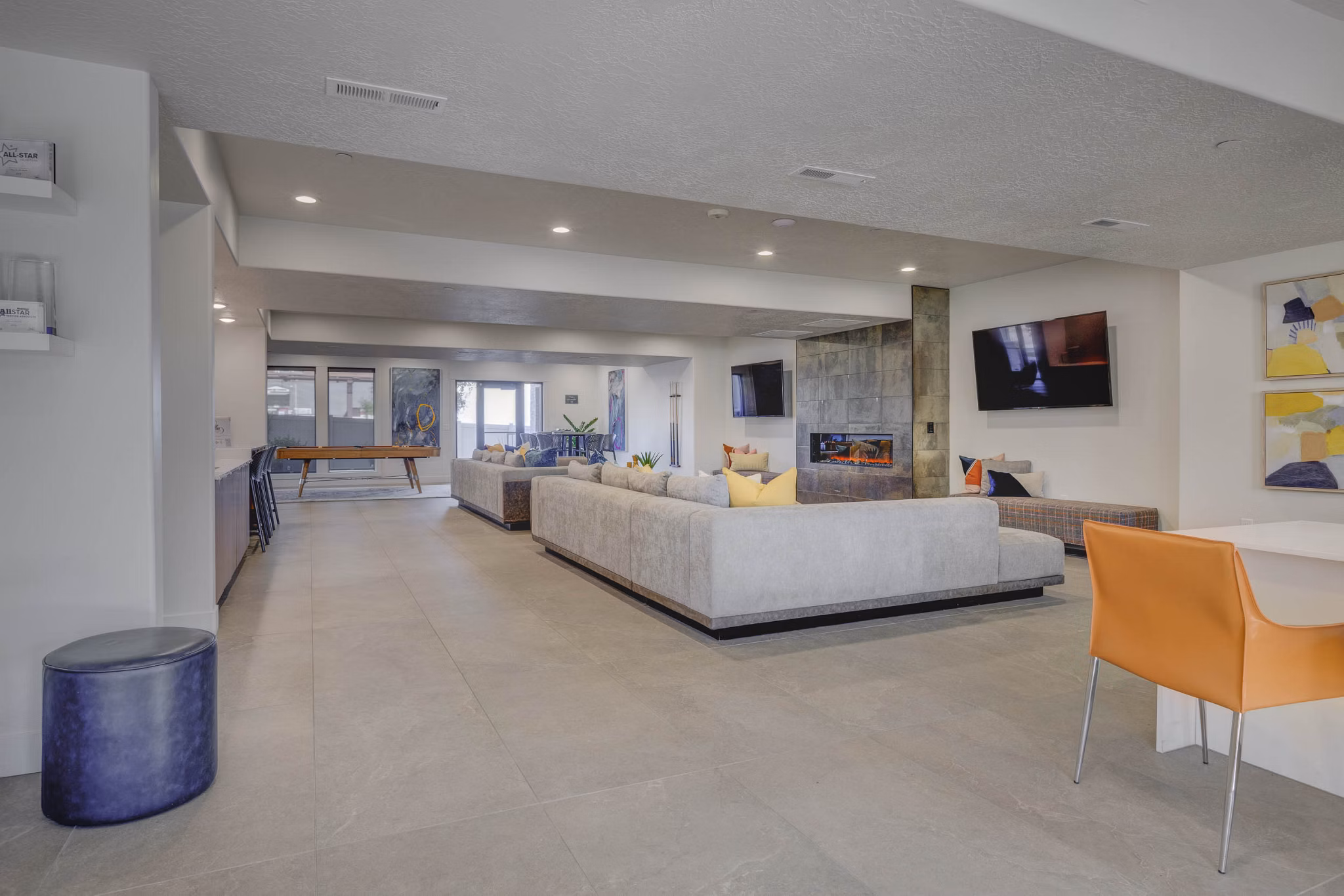 Clubhouse featuring modern lounge and community workspace at Villas on Main Apartments