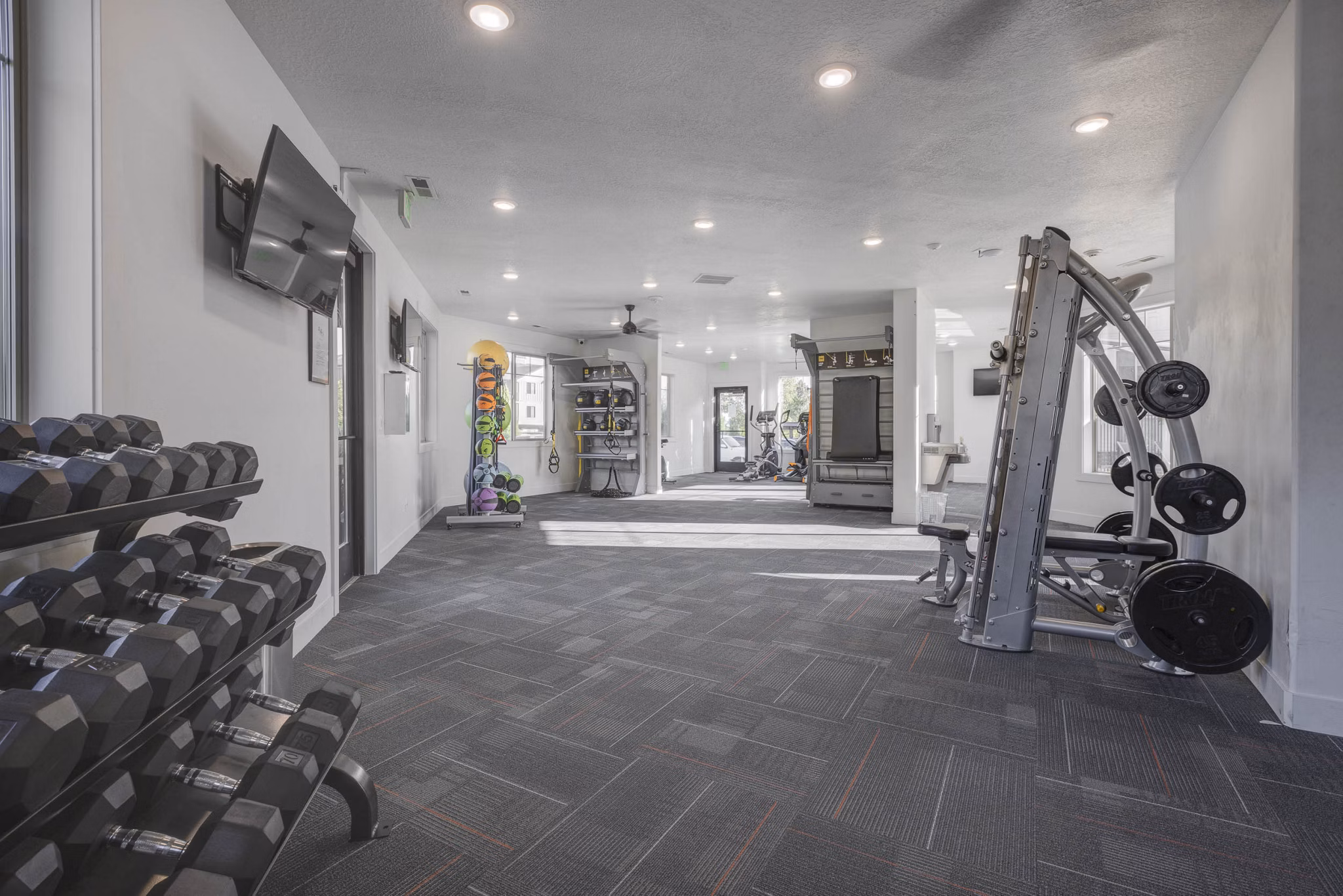 State-of-the-art fitness center with a variety of equipment at the Villas on Main Apartments