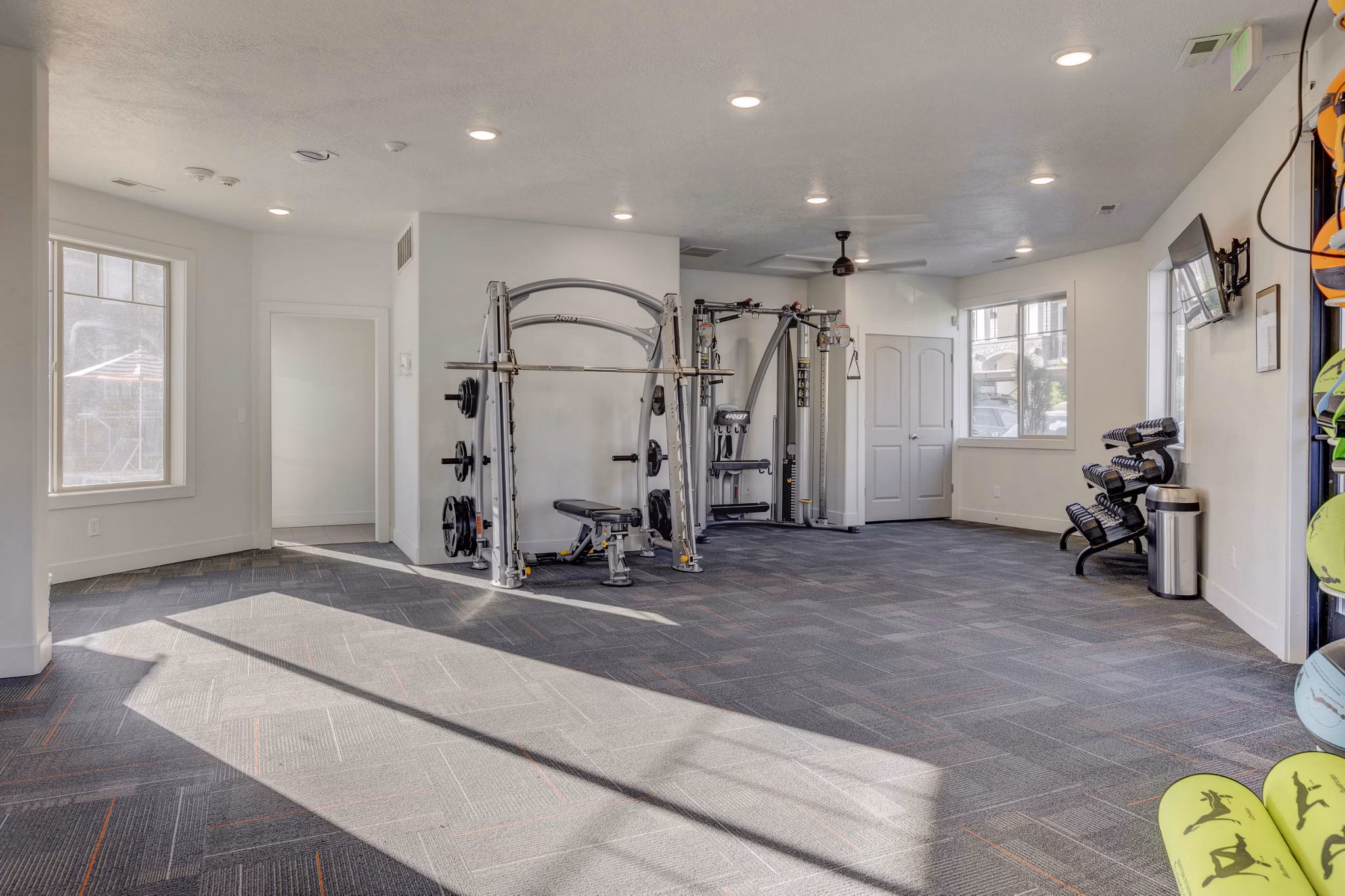 State-of-the-art fitness center with modern equipment at the Villas on Main Apartments