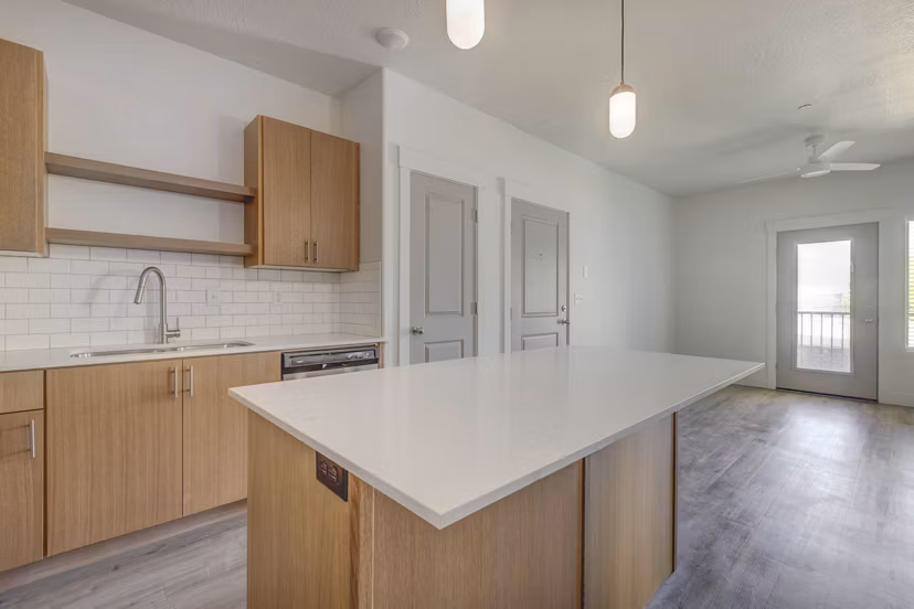 Modern kitchen with stainless steel appliances at Villas on Main Apartments