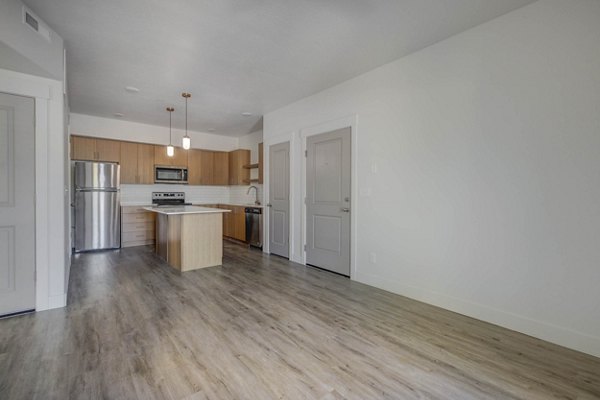 Spacious living room with modern decor at Villas on Main Apartments