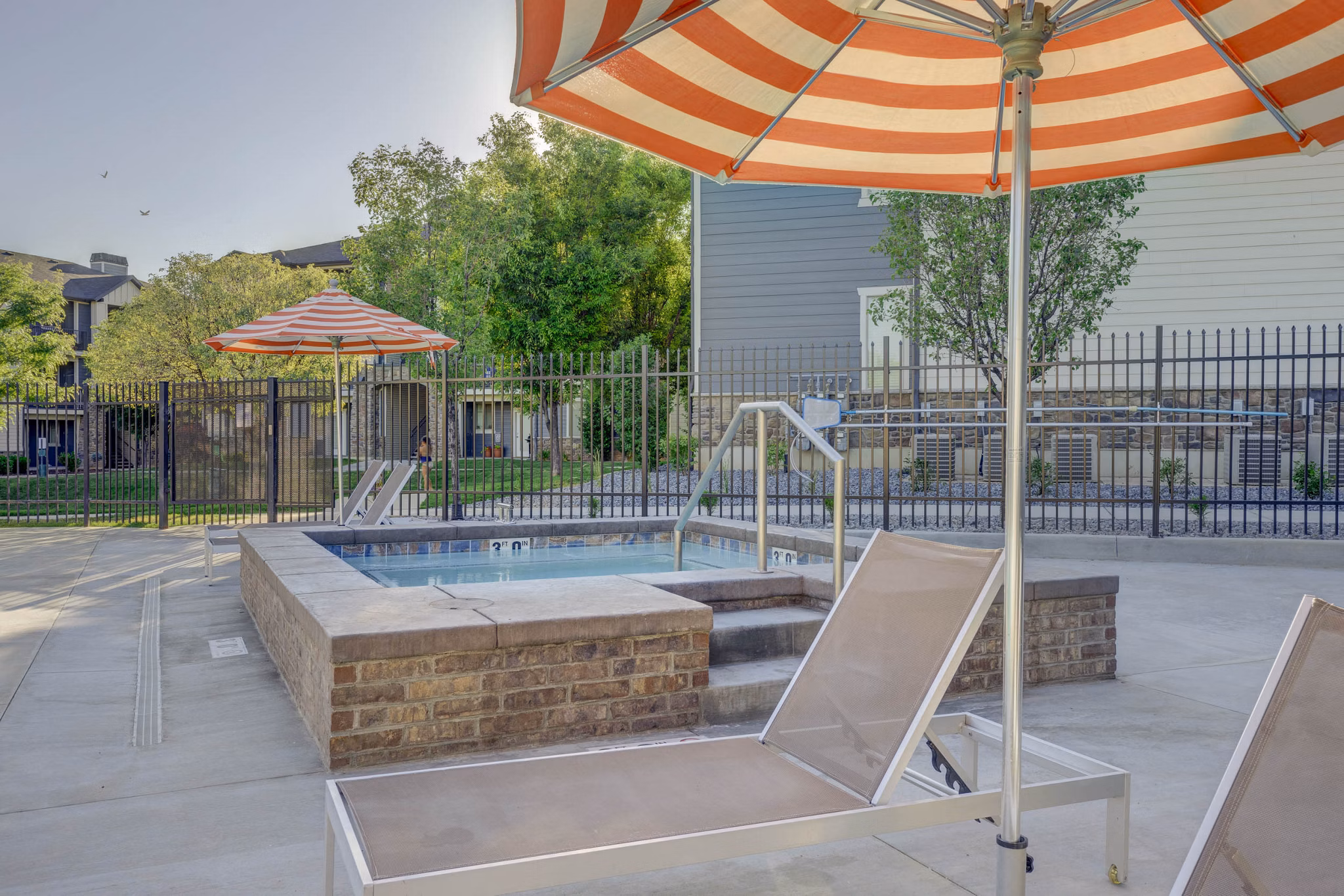 Relaxing hot tub with cozy seating at Villas on Main Apartments, perfect for unwinding in style