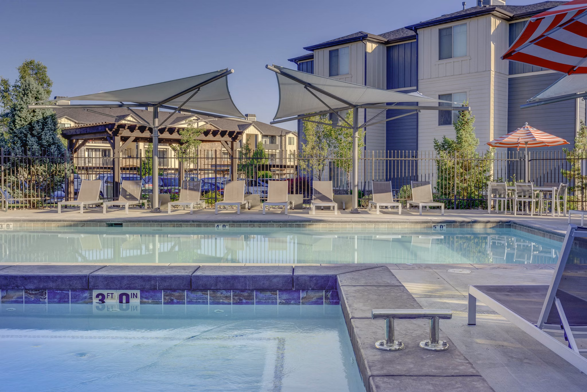 Luxury pool area at Villas on Main Apartments, offering relaxation and recreation for residents