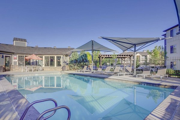 Luxury pool at Villas on Main Apartments with lounging areas and water features