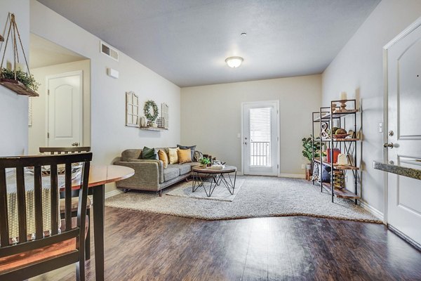 Spacious living room with modern furnishings in Pinnacle Highbury Apartments