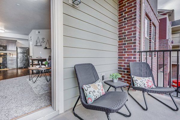 Cozy balcony space with seating and scenic views at Pinnacle Highbury Apartments