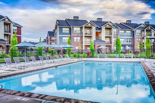 Relaxing poolside with sun loungers at Pinnacle Highbury Apartments, luxurious living in a prime location