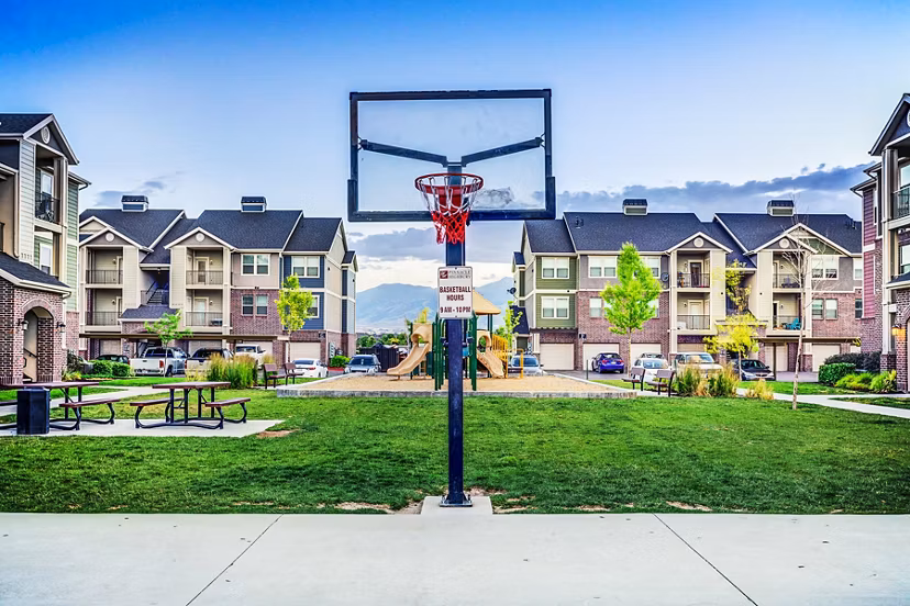 Indoor basketball court with hardwood flooring at Pinnacle Highbury Apartments