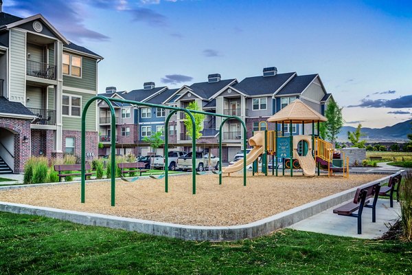Children's playground with vibrant equipment at Pinnacle Highbury Apartments