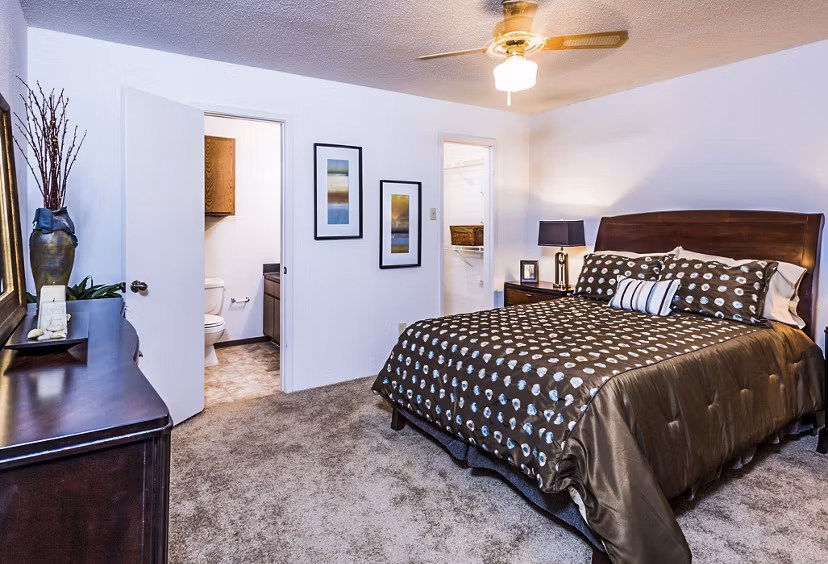 Cozy bedroom with modern decor at Fountainhead Apartments, featuring plush bedding and elegant lighting